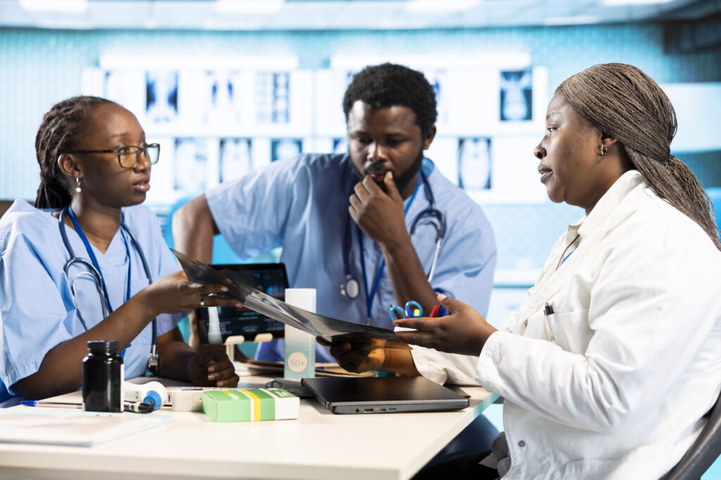 black expert discussing with junior nurses to find the best treatment options. Chronic Disease Management